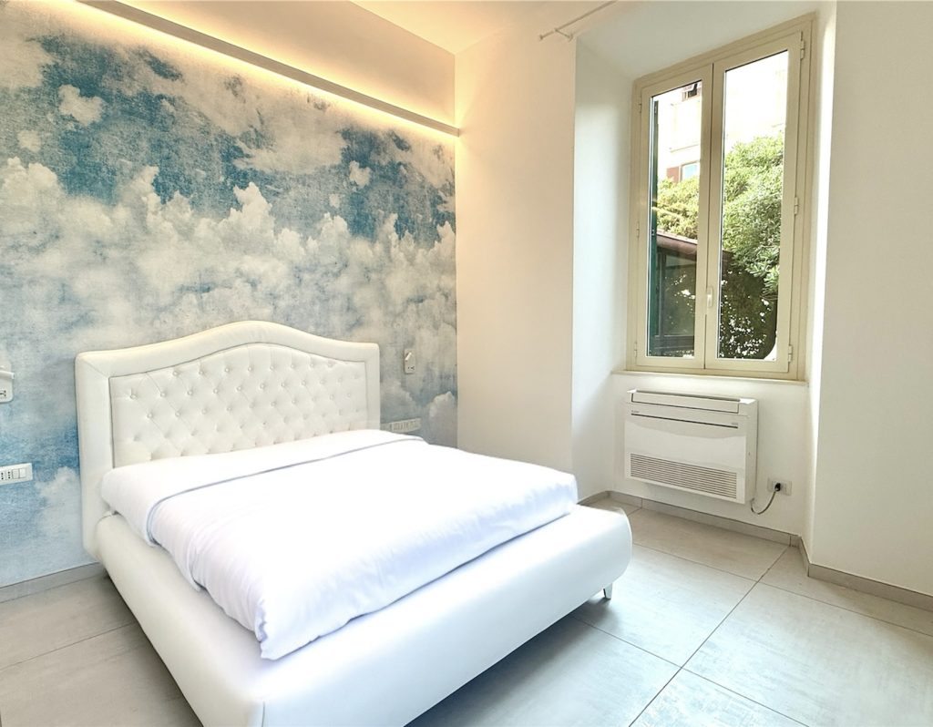King-size bed in vacation apartment in Civitavecchia, perfect for couples and families