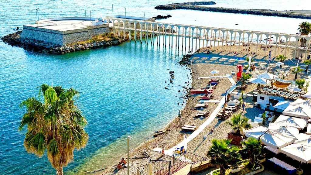 Peaceful sandy beach in Civitavecchia with calm Mediterranean waters and gentle waves – perfect for a relaxing Italian seaside getaway.